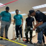 SETT skilled trades students learning solar on mock roof at OIC Philadelphia